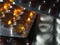 Närbild på flera blisterförpackningar med piller. En förpackning innehåller gulaktiga kapslar, en annan vita tabletter och en tredje mörkbruna piller. Kanske en av dem innehåller folic acid svenska.